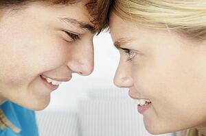 Teenage boy and girl close up profile