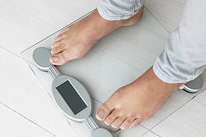 Close up detail girl weighing herself