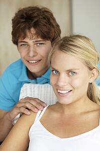Portrait teenage girl and boy at home