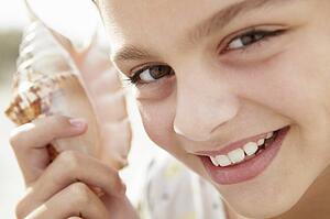 Young girl with seashell