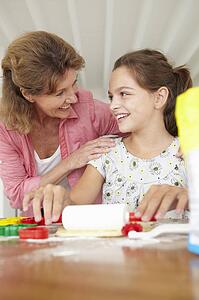 Young girl baking with grandmother