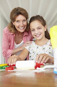Young girl baking with grandmother