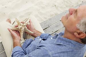 Senior man holding starfish