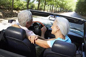 Senior couple in sports car