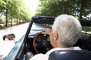 Senior man in sports car