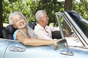 Senior couple in sports car