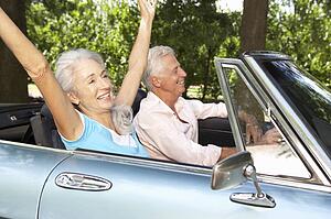 Senior couple in sports car