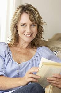 Mid age woman reading a book