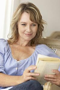Mid age woman reading a book