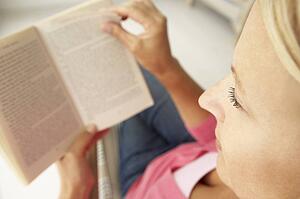 Senior woman reading book at home