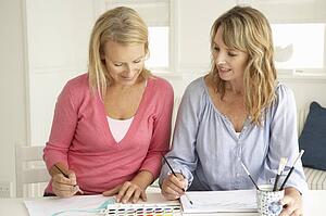 Mid age women painting with watercolors