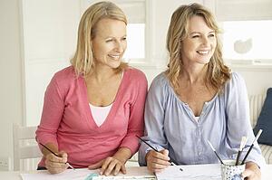 Mid age women painting with watercolors