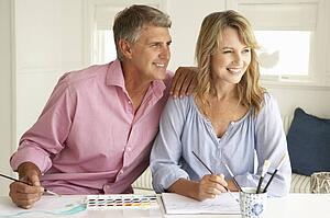 Mid age couple painting with watercolors