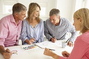 Mid age couples painting with watercolors
