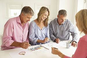 Mid age couples painting with watercolors