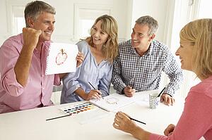 Mid age couples painting with watercolors