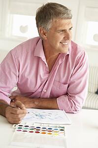 Mid age man painting with watercolors