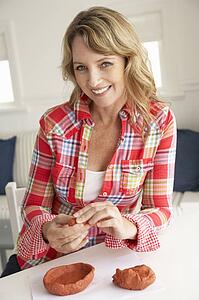 Mid age woman clay modelling