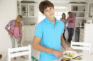 Teenagers reluctantly doing housework