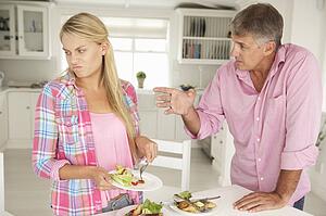 Father making teenage daughter do chores at home