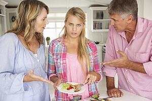 Parents making teenage daughter do chores at home