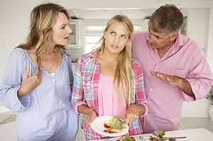 Parents making teenage daughter do chores at home