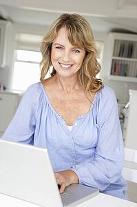 Mid age woman using laptop