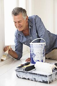 Senior man decorating house