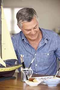 Senior man model making