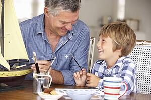 Senior man model making with grandson