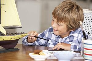 Young boy making model ship
