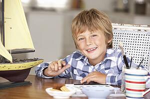 Young boy making model ship