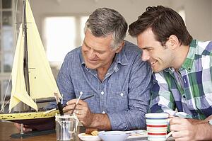 Adult father and son model making