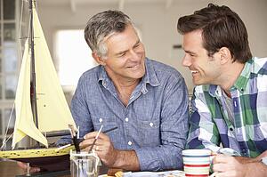 Adult father and son model making