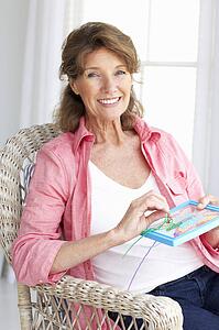 Senior woman doing cross stitch