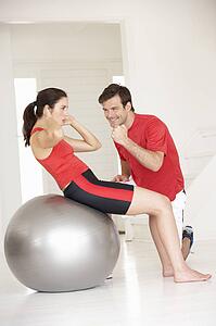 Woman with personal trainer in home gym