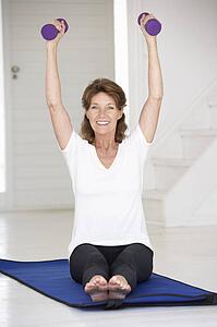 Senior woman exercising at home
