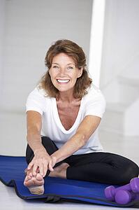 Senior woman exercising at home