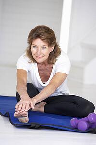 Senior woman exercising at home