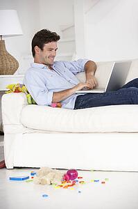 Busy father working on laptop