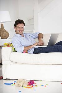 Busy father working on laptop