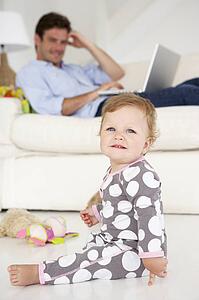 Busy father working on laptop