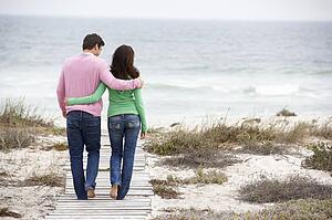 Couple walking by the sea