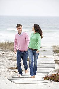 Couple running along beach path