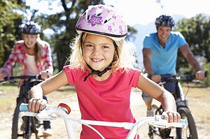 Young family on country bike ride