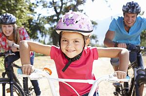 Young family on country bike ride