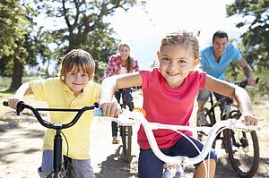 Young family on country bike ride