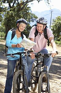 Senior couple with map on country bike ride