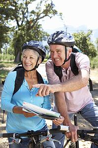 Senior couple with map on country bike ride