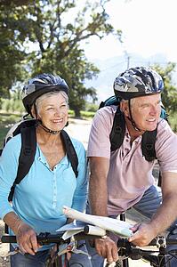 Senior couple with map on country bike ride